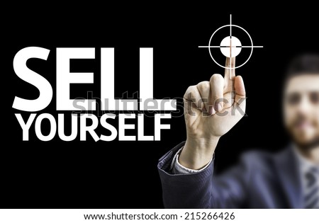 Business man pointing to black board with text: Sell Yourself