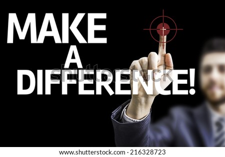 Business man pointing to black board with text: Make a Difference
