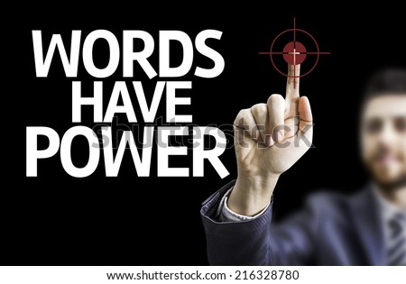 Business man pointing to black board with text: Words Have Power