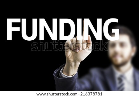 Business man pointing to black board with text: Funding