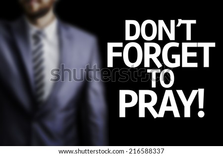 Don\'t Forget to Pray written on a board with a business man on background