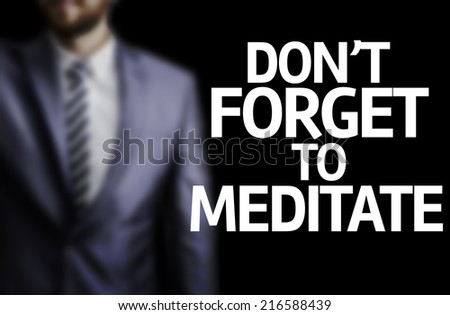 Don't Forget to Meditate written on a board with a business man on background