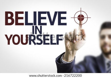 Business man pointing to transparent board with text: Believe in Yourself