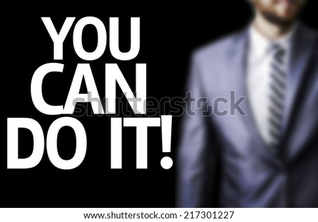 You can Do It! written on a board with a business man on background