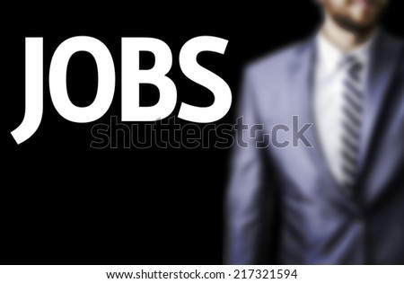 Jobs written on a board with a business man on background