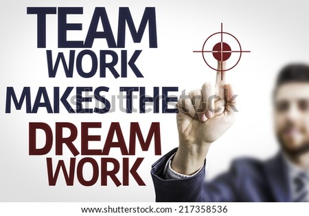 Business man pointing to transparent board with text: Team Work Makes the Dream Work