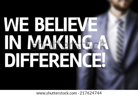 We Believe in Making a Difference written on a board with a business man on background