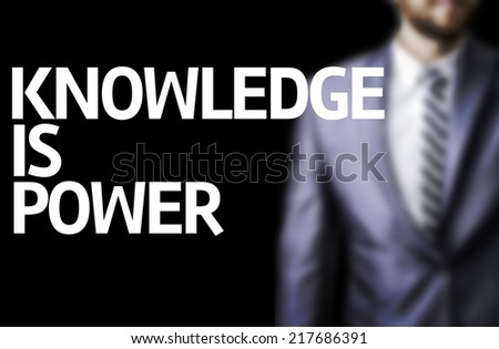 Knowledge is Power written on a board with a business man on background