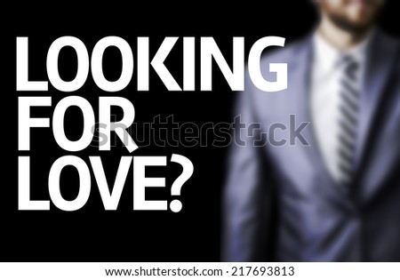 Looking for Love? written on a board with a business man on background
