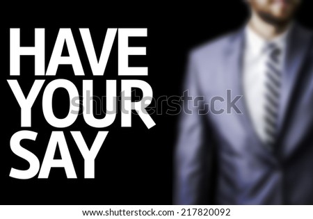 Have Your Say written on a board with a business man on background