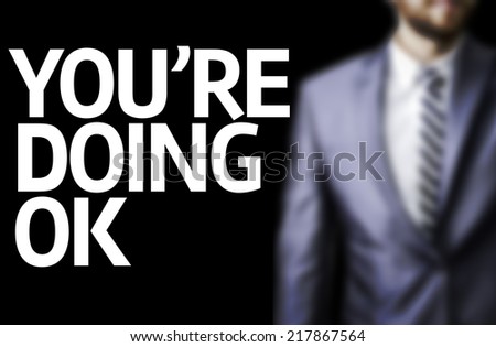 You Are Doing Okay written on a board with a business man on background