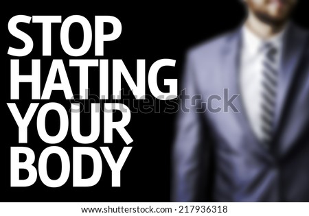 Stop Hating Your Body written on a board with a business man on background