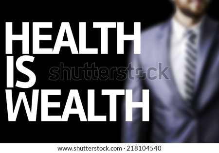 Health is Wealth written on a board with a business man on background