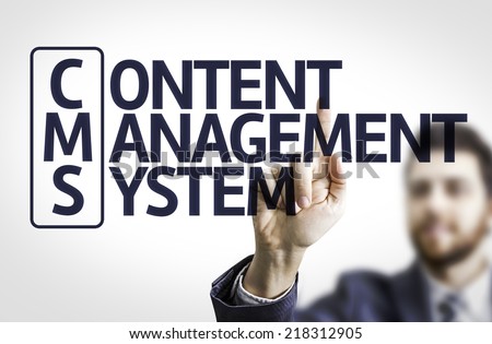 Business man pointing to transparent board with text: Content Management System