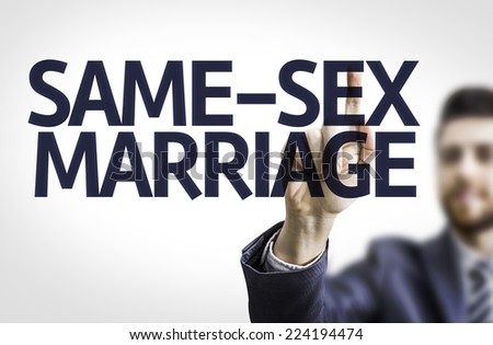 Business man pointing to transparent board with text: Same-Sex Marriage