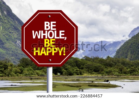 Be Whole Be Happy written on red road sign with landscape background