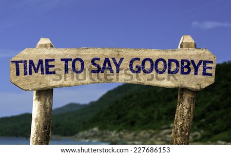 Time To Say Goodbye wooden sign with a beach on background