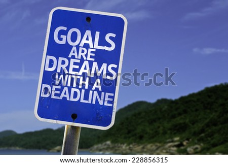 Goals Are Dreams With a Deadline sign with a beach on background
