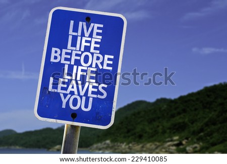 Live Life Before Life Leaves You sign with a beach on background