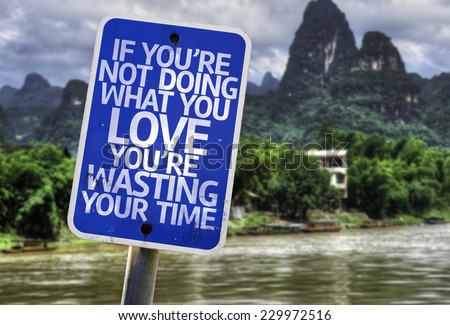 If You\'re Not Doing What you Love You\'re Wasting your Time sign with a forest background