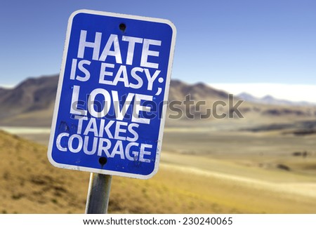 Hate is Easy Love Takes Courage sign with a desert background