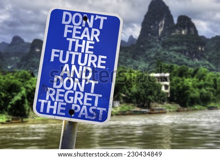 Don\'t Fear The Future and Don\'t Regret The Past sign with a forest background