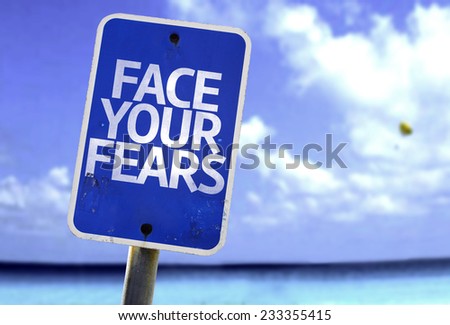 Face Your Fears sign with a beach on background