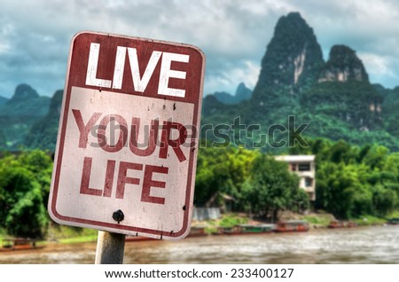 Live Your Life sign with a exotic landscape on background
