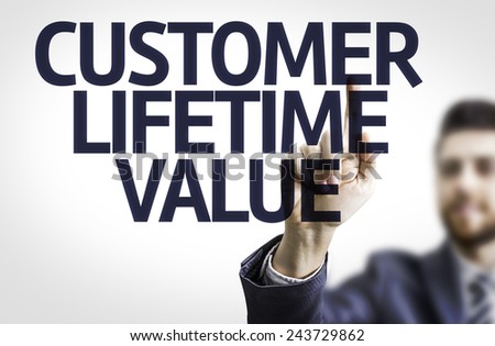 Business man pointing to transparent board with text: Customer Lifetime Value