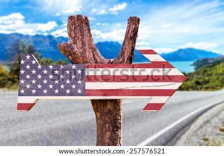United States Flag wooden sign with a road background