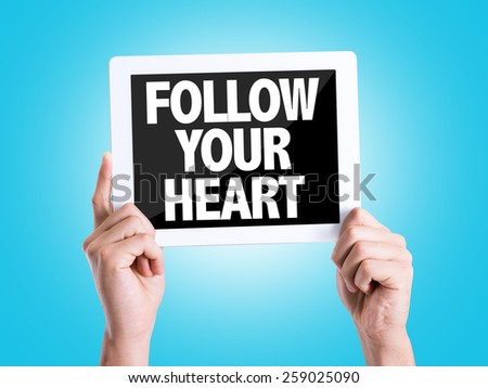 Tablet pc with text Follow Your Heart with blue background
