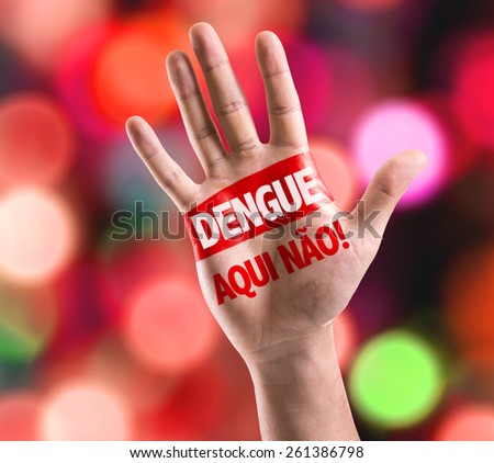Dengue, No Here! (in Portuguese) sign painted on hand raised on bokeh background