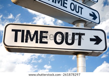 Time Out direction sign on sky background