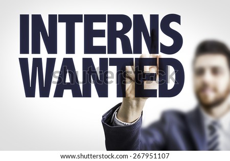 Business man pointing the text: Interns Wanted