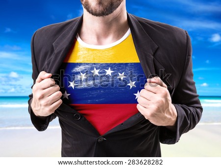 Businessman stretching suit with Venezuela flag on beach background