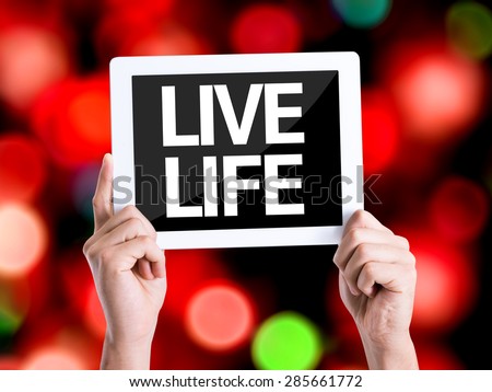 Tablet pc with text Live Life with bokeh background