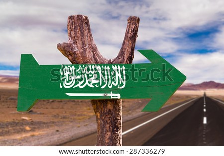Saudi Arabia flag wooden sign with desert road background
