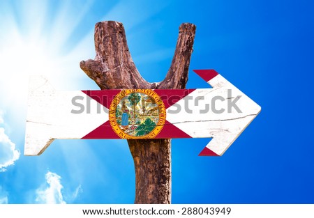 Florida Flag wooden sign with sky background