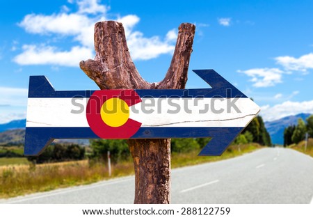 Colorado Flag wooden sign with road background