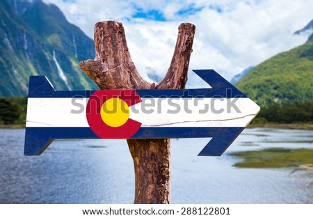 Colorado Flag  wooden sign with mountains background