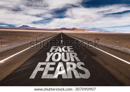 Face Your Fears written on desert road