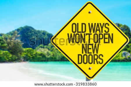 Old Ways Wont Open New Doors sign with beach background