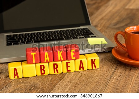 Take a Break written on a wooden cube in a office desk