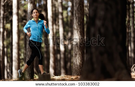 runner trail running training in forest outdoors, healthy fitness wellness athlete portrait
