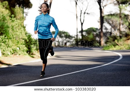 portrait of a healthy woman training for running along a mountain road alone. fitness wellness athlete