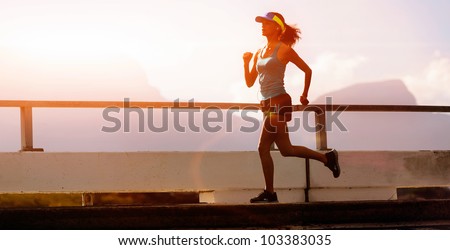 runner training at sunset, silhouette of fitness marathon woman with lens flare and action