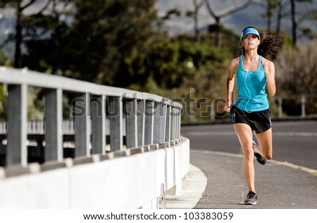 runner running over a bridge alone the road, training for fitness and marathon healthy lifestyle athlete with headphones