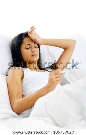 Sick woman lying in bed with thermometer and fever. unhappy face isolate on white background