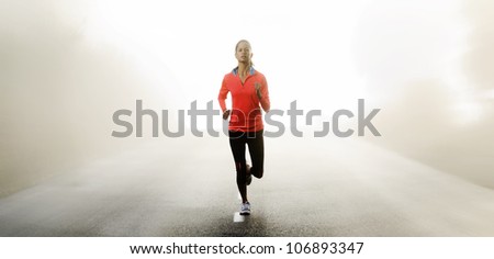 Panorama of athlete running outdoors on a road training and exercising for a marathon endurance sport.