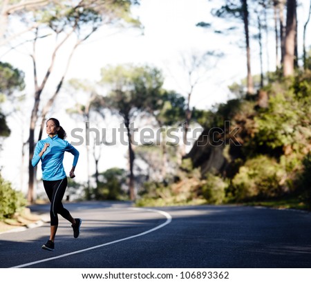 Fitness athlete training alone on a mountain road. Running endurance marathon woman exercising for healthy lifestyle and wellness. panorama with copyspace